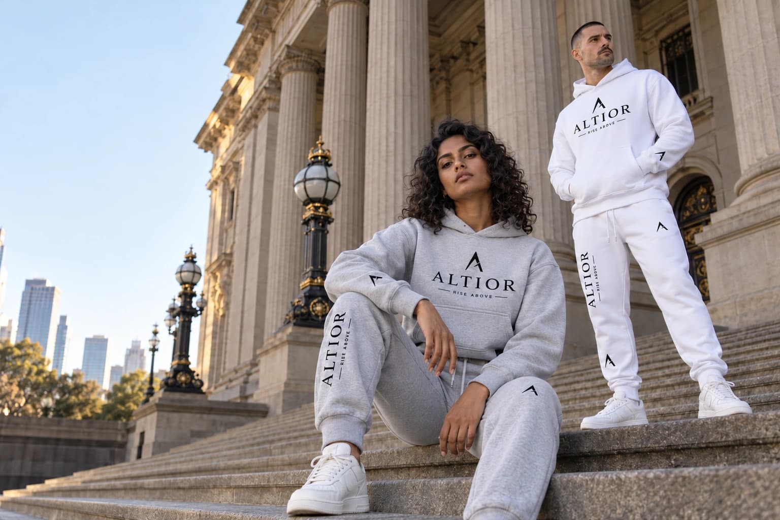 Generated editorial of two adult models in grey and white ALTIOR layers on steps inspired by Melbourne's Parliament House.
