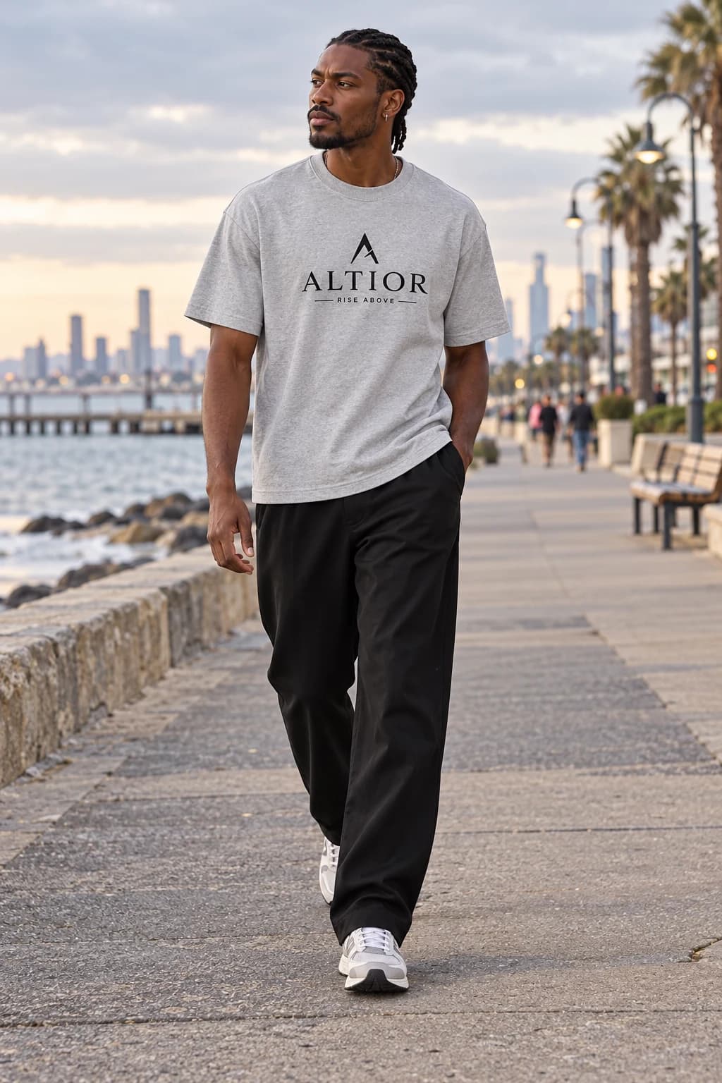 Generated ALTIOR editorial: adult man wearing carbon ash ascend tee in a St Kilda promenade-inspired setting.