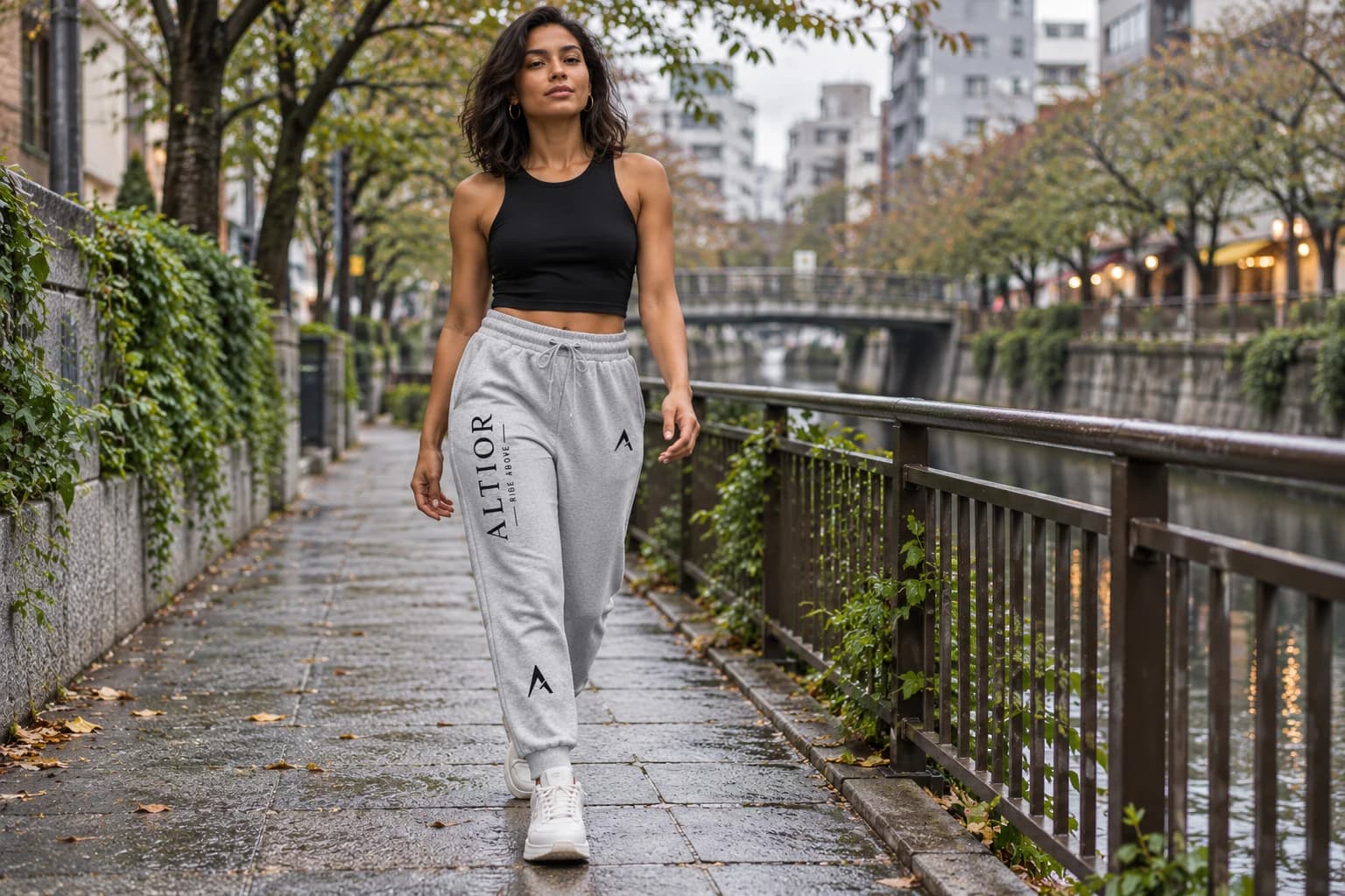 Generated ALTIOR editorial: adult woman wearing carbon ash jogger in a Nakameguro canal-inspired setting.