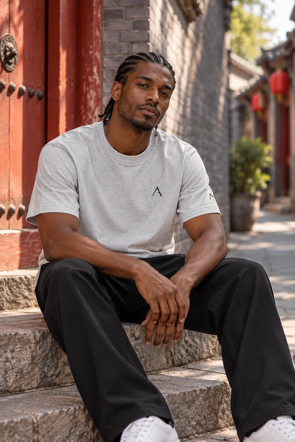 Generated ALTIOR editorial: adult man wearing carbon ash core tee in a Beijing hutong-inspired setting.