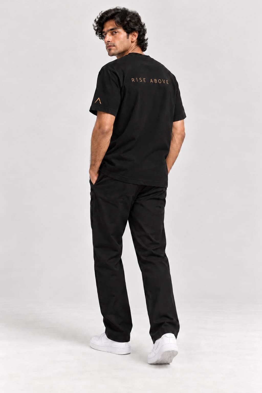 Core tee — Black with gold detailing, back view on model