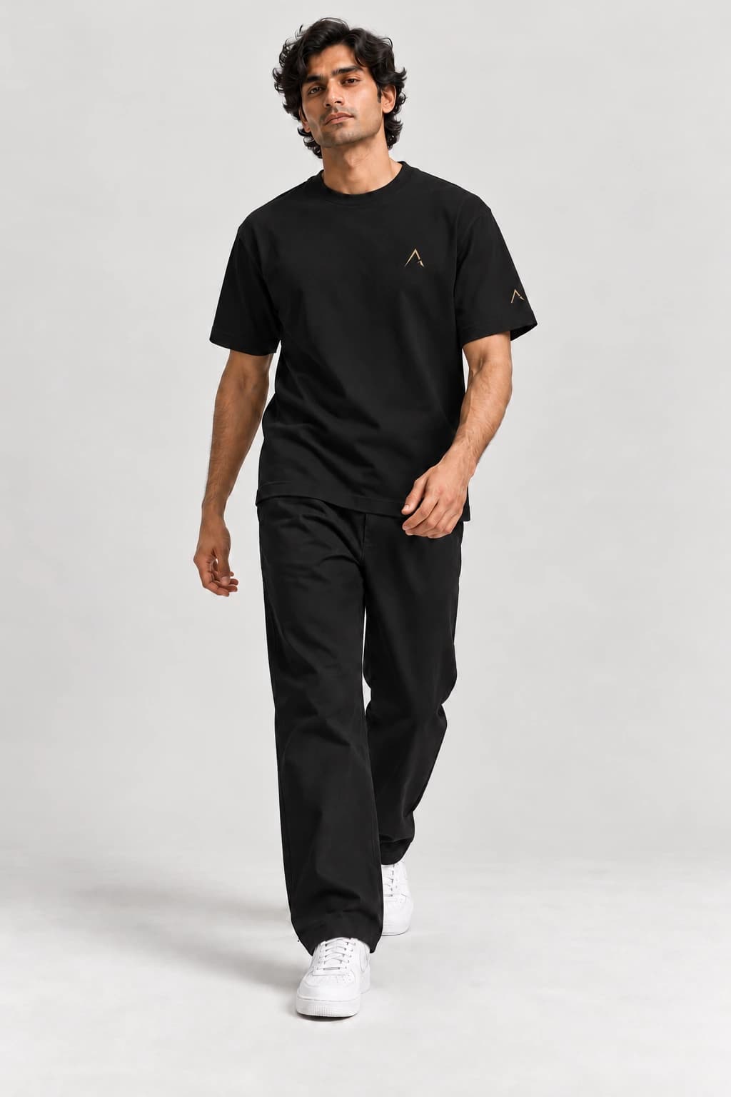 Core tee — Black with gold detailing, front view on male model