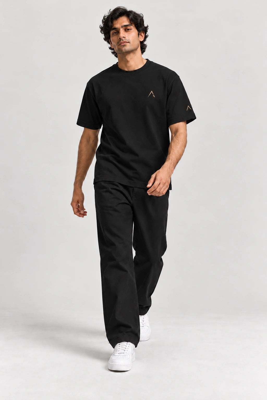 Core tee — Black with gold detailing, front view on male model