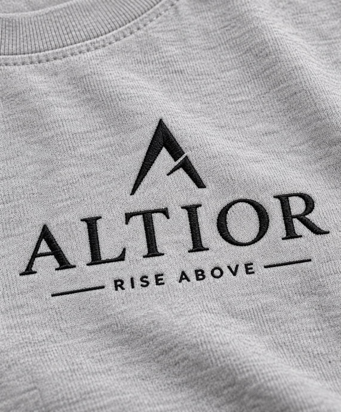 Signature tee — Grey with black detailing, AI-generated embroidered branding close-up