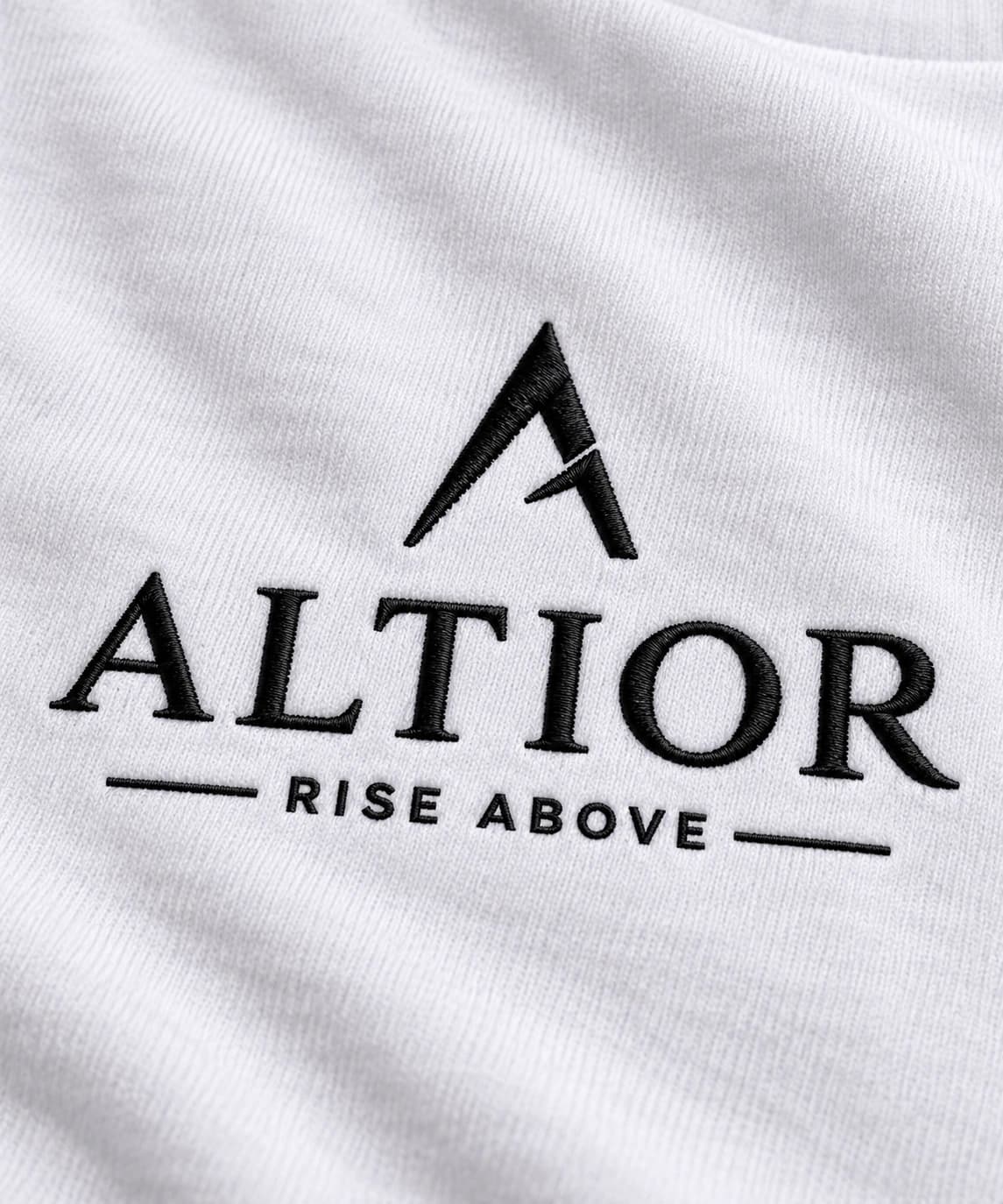 Signature tee — White with black detailing, AI-generated embroidered branding close-up