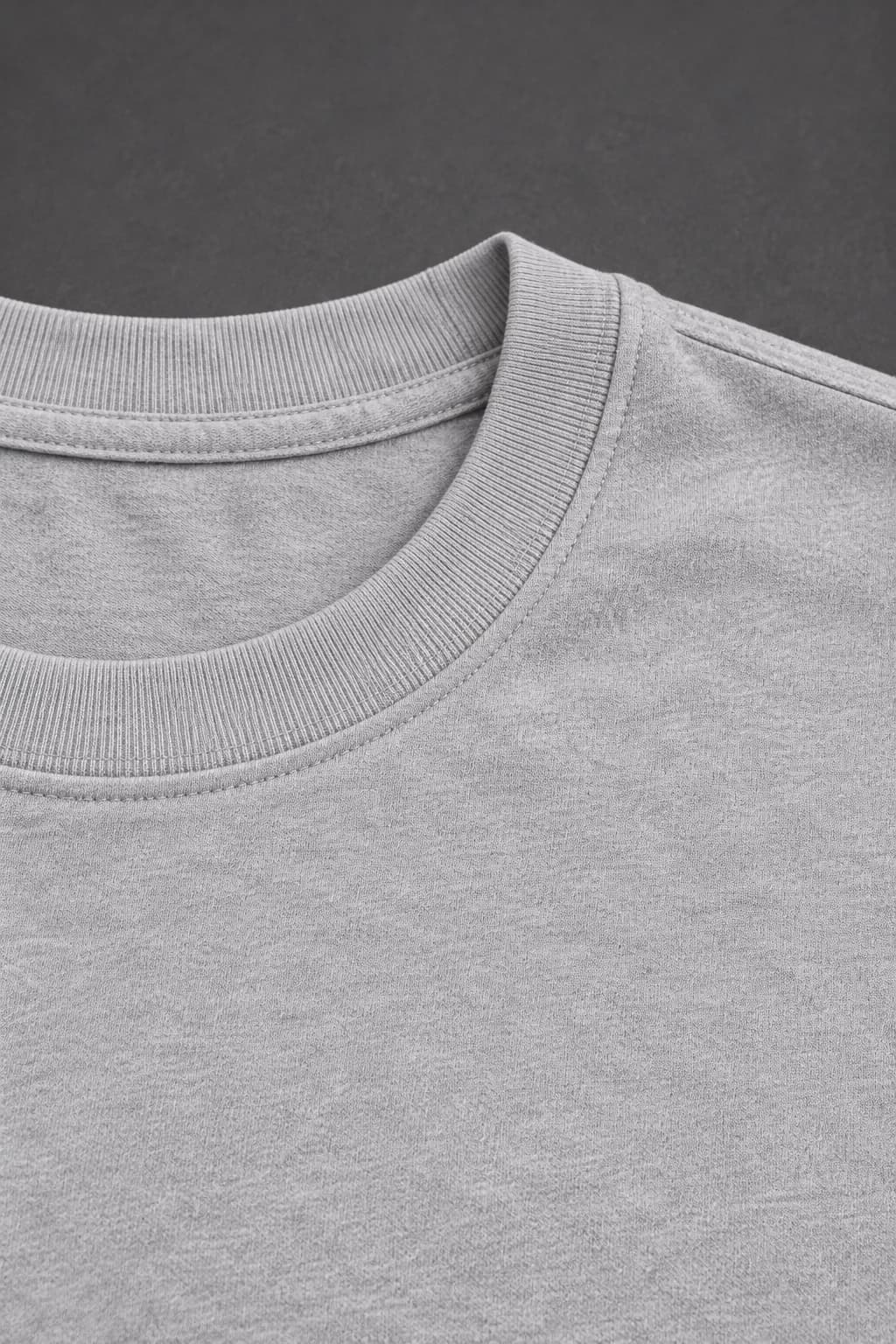 Signature tee — Grey with black detailing, AI-generated fabric and seam close-up study