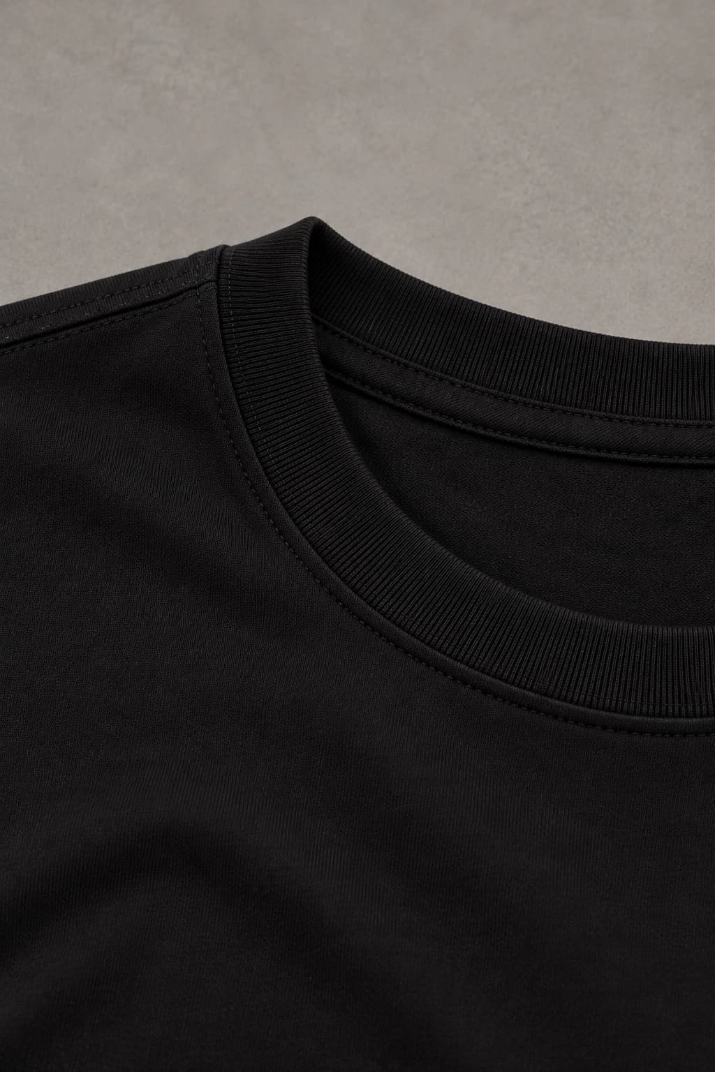 Signature tee — Black with gold detailing, AI-generated fabric and seam close-up study