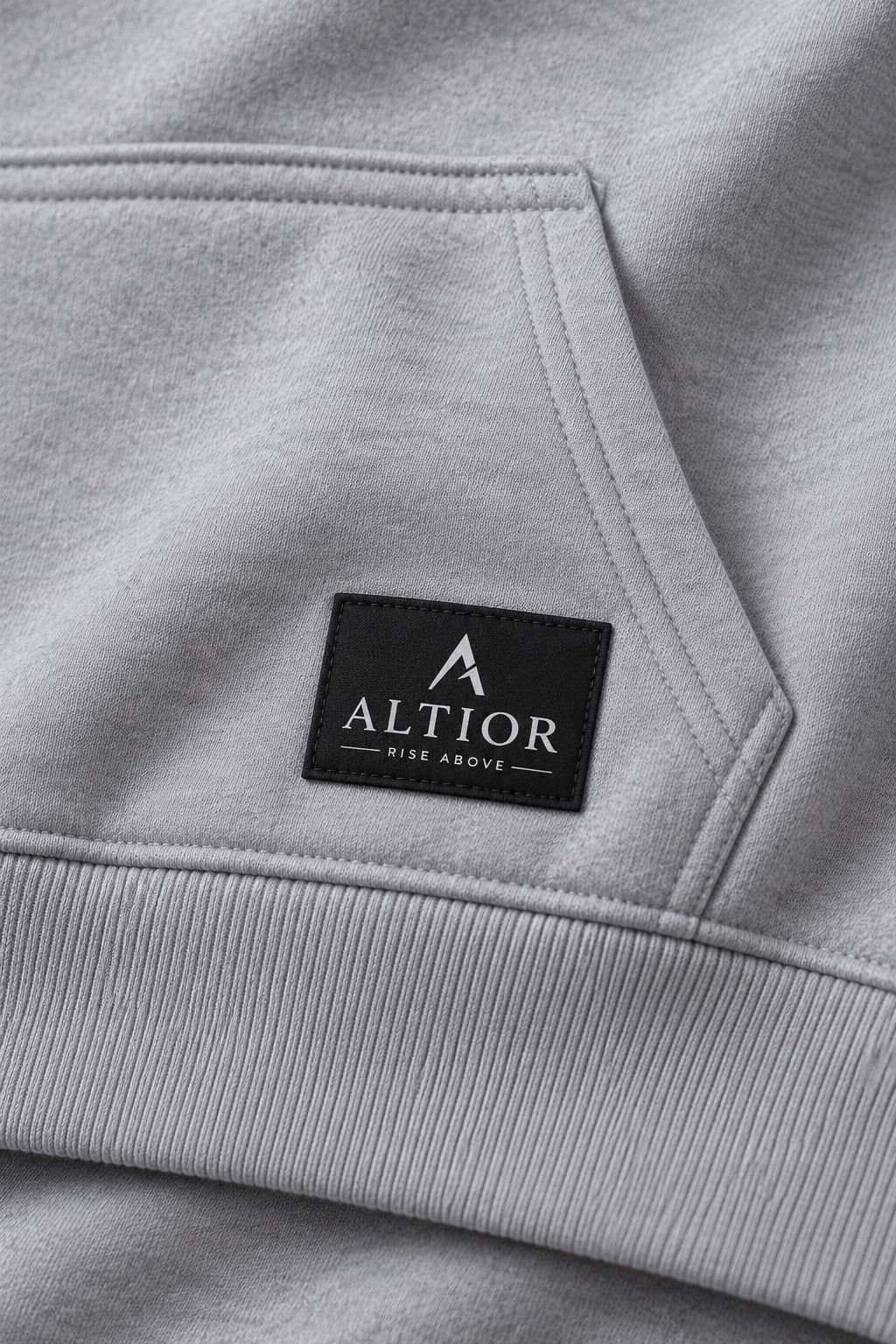 Cropped hoodie — Grey with black detailing, AI-generated badge and fabric close-up study