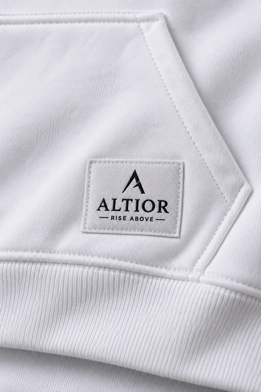 Cropped hoodie — White with black detailing, AI-generated badge and fabric close-up study