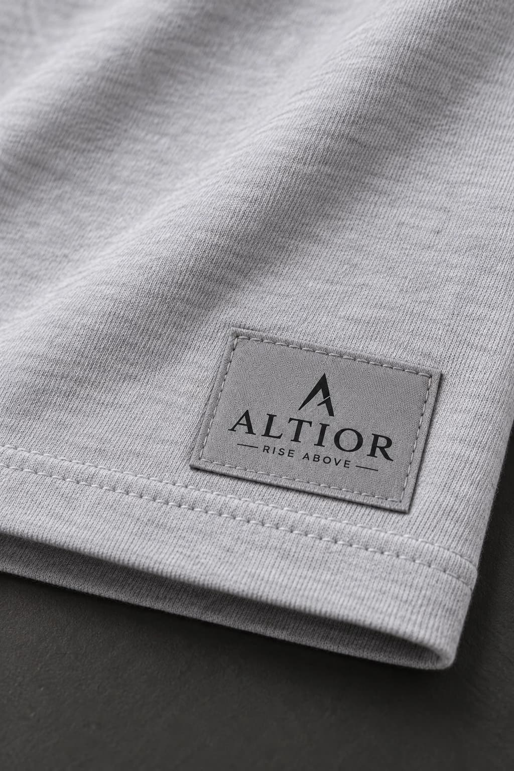 Cropped tee — Grey with black detailing, AI-generated badge and fabric close-up study