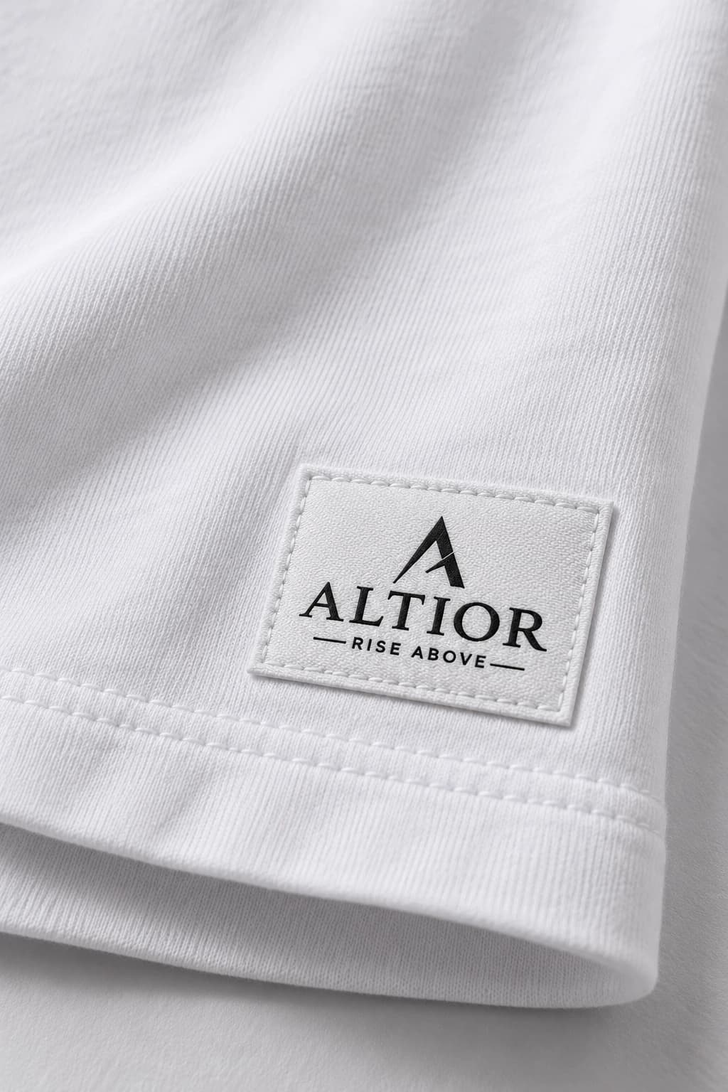 Cropped tee — White with black detailing, AI-generated badge and fabric close-up study