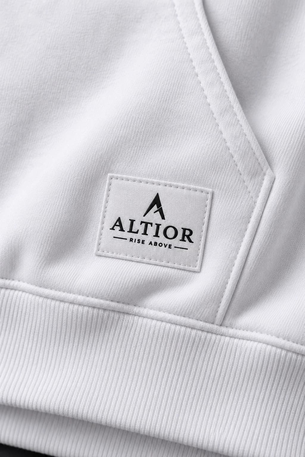 500 GSM hoodie — White with black detailing, AI-generated badge and fabric close-up study