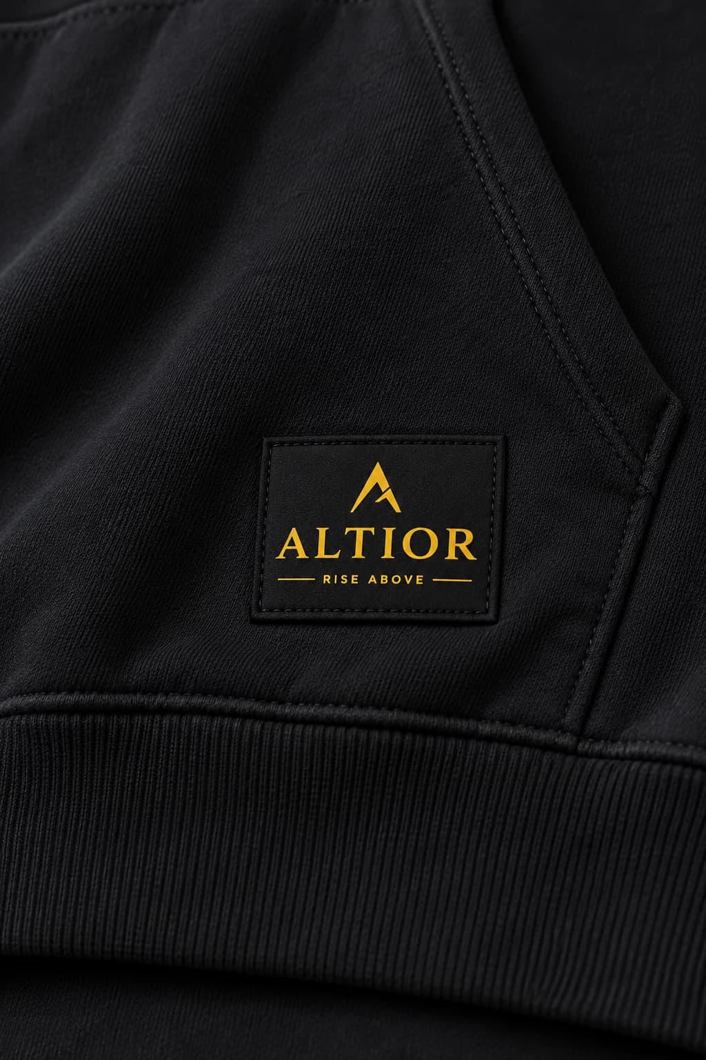500 GSM hoodie — Black with gold detailing, AI-generated badge and fabric close-up study