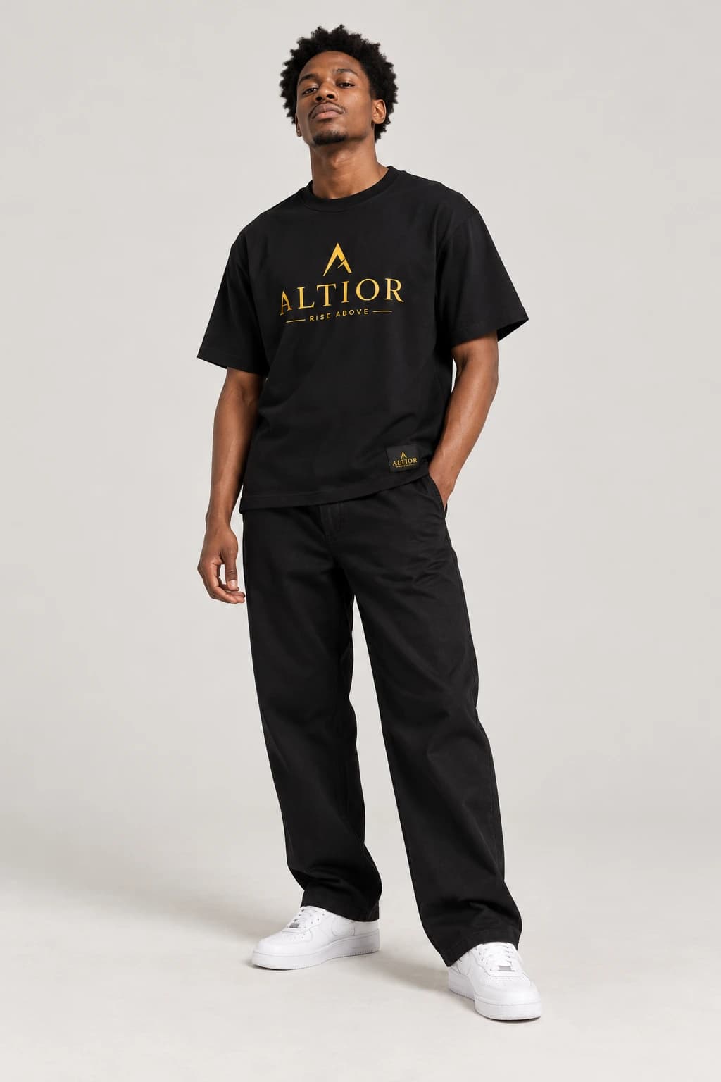 Signature tee — Black with gold detailing, front view on male model